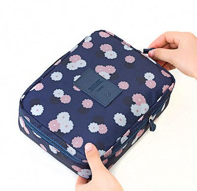 Women's waterproof travel makeup case, compact and decorated with blue flowers.