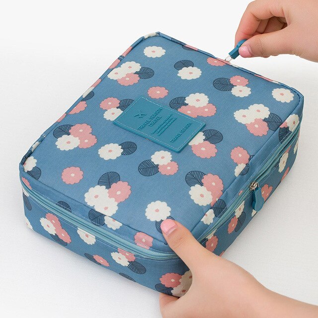 Women's compact cosmetic travel bag, waterproof, showcasing a beautiful floral pattern.