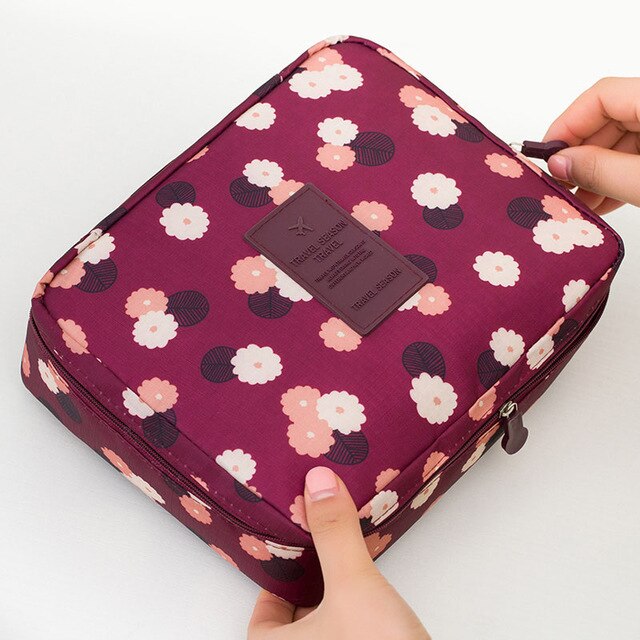 Dark blue floral waterproof makeup organizer, perfect for women's on-the-go beauty.