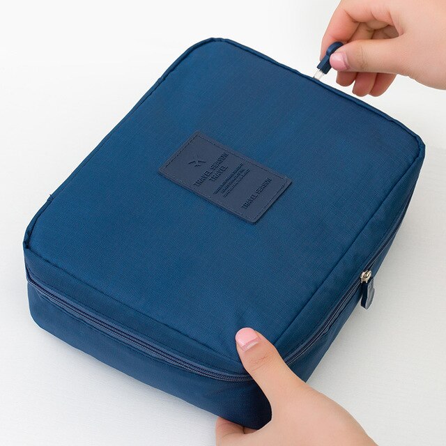 Portable waterproof cosmetic storage for women, with a chic dark blue flower design.