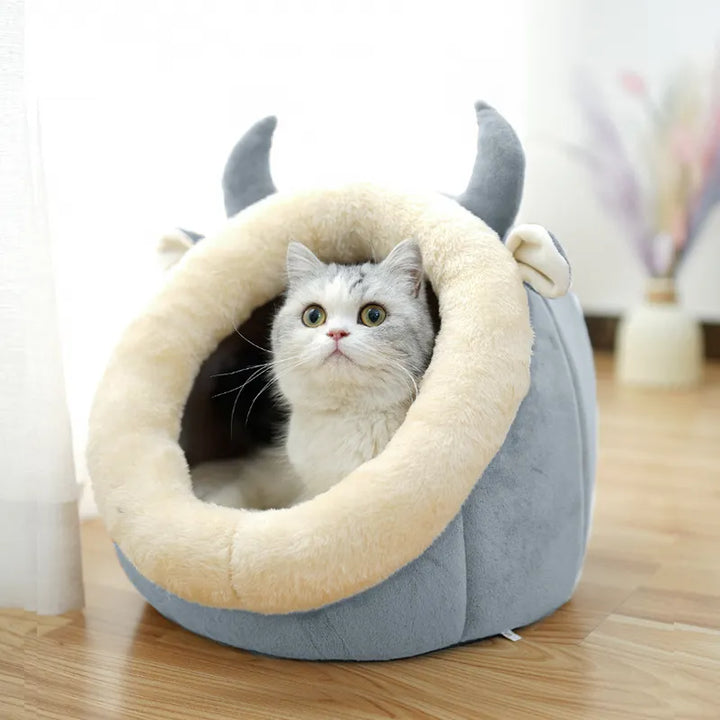 Soft, enclosed Cat Cave Bed offers a cozy hideaway for cuddling felines. Features a playful ear design.