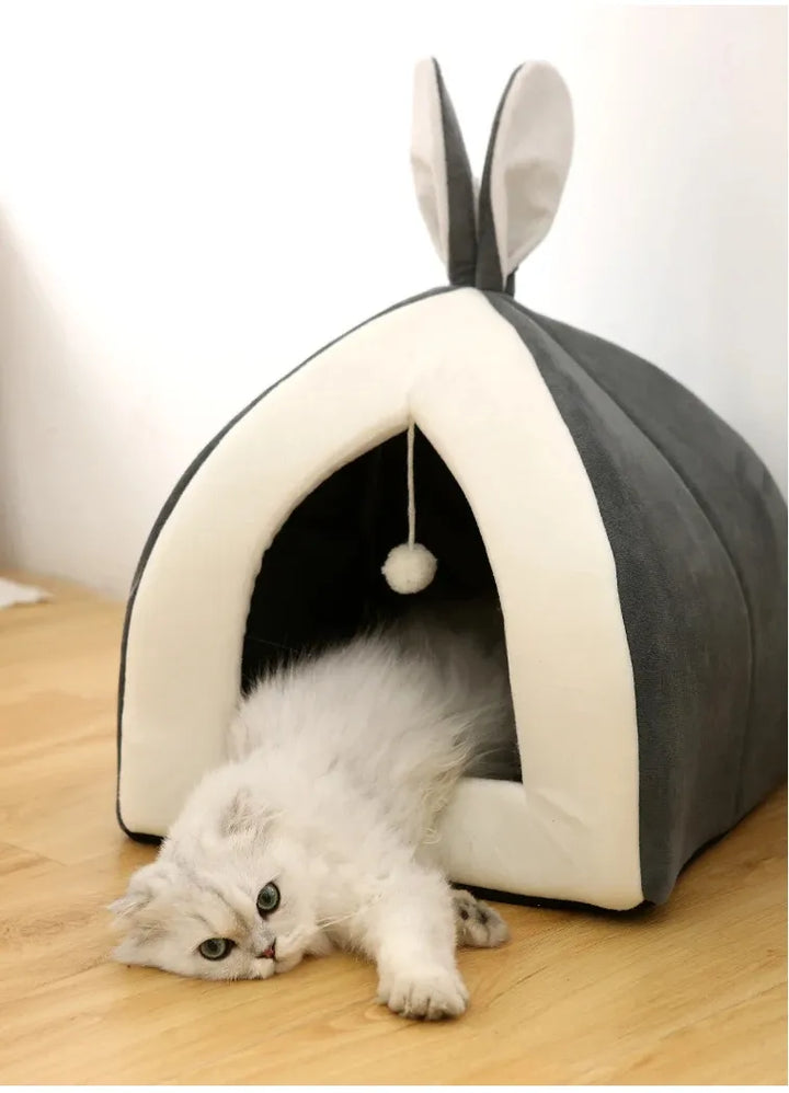 Pet's Cozy Cave Cat Bed with integrated play ball. A washable, warm, and secure pet accessory.