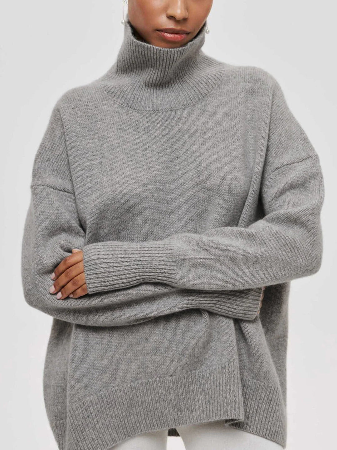 Chic women's oversized knit sweater with a high turtleneck, versatile for fall and winter.