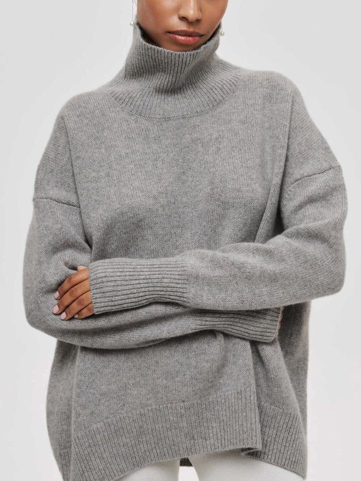 Chic women's oversized knit sweater with a high turtleneck, versatile for fall and winter.