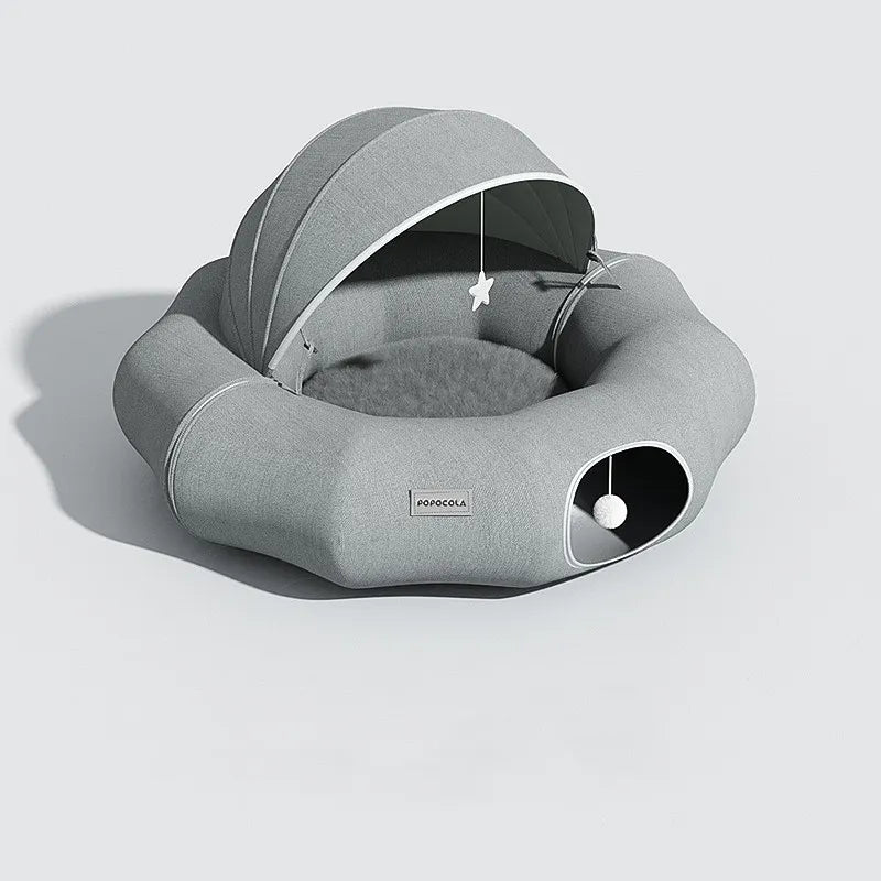Interactive cat & small dog bed: a plush pet cave with an attached toy for playful moments.