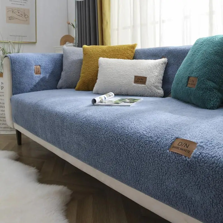 Full view of a multi-size waterproof sherpa fleece sofa cover on a living room couch, enhancing decor & providing protection.