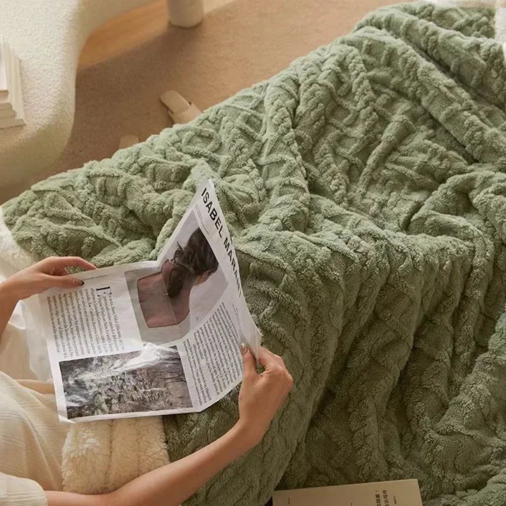 Soft polyester winter blanket draped over a sofa, illustrating cozy warmth and home decor
