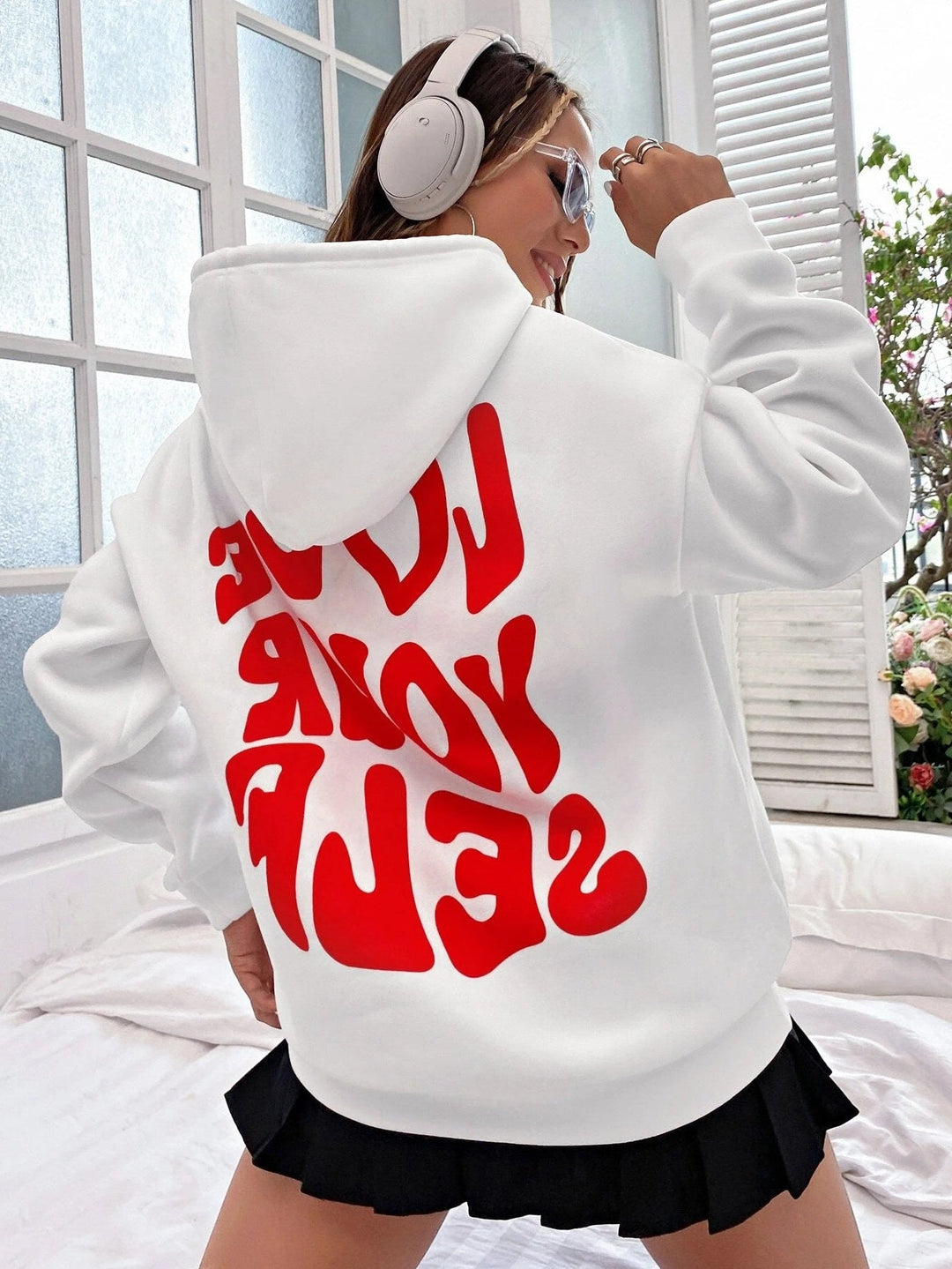 Soft pink women's drawstring pullover hoodie with a spacious kangaroo pocket, ideal for loungewear.
