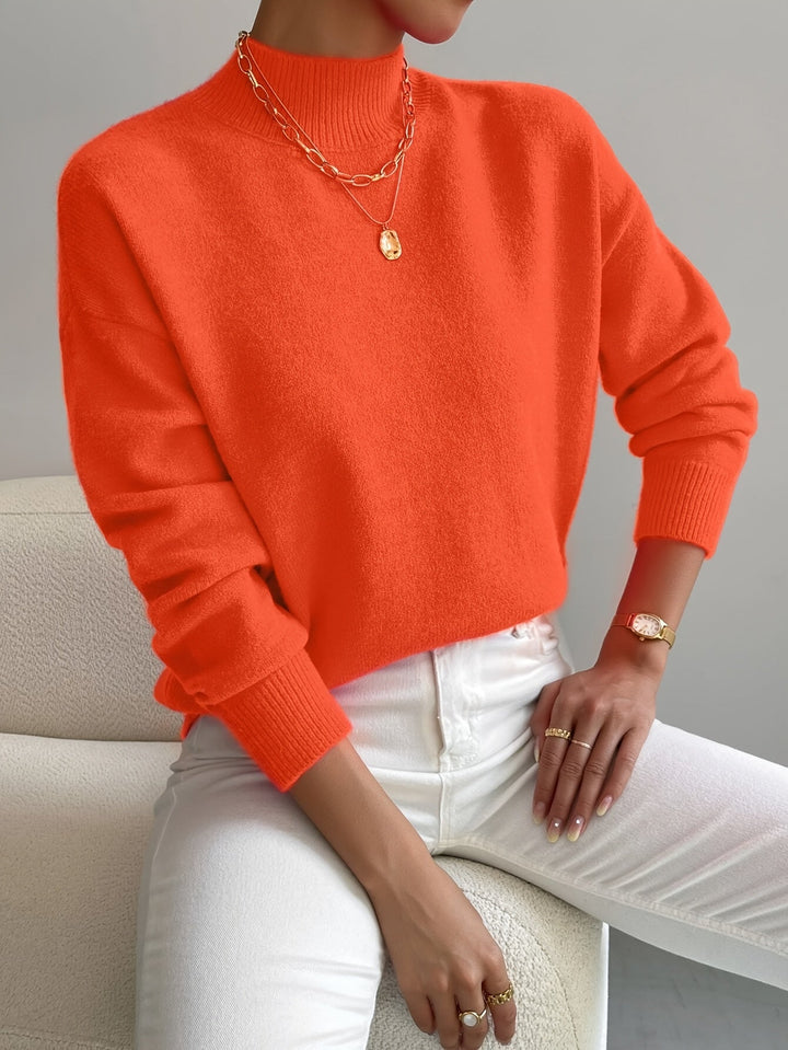 Modern women's high neck knit jumper, cozy long sleeve sweater for stylish winter fashion.