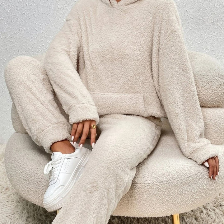 Model wearing a comfortable women's hoodie set with drawstring lounge pants, ideal for at-home relaxation.
