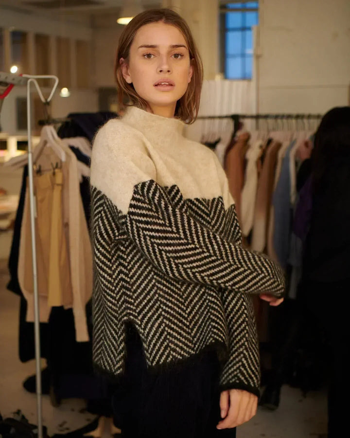 Model wearing a casual long sleeve loose knit high collar sweater, ideal for everyday winter wear.