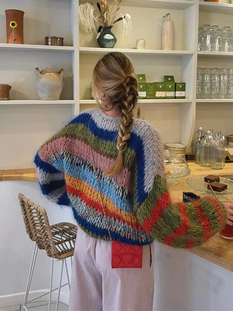 Casual women's blue knit winter sweater with vibrant multicolor pattern, featuring a crew neck style.