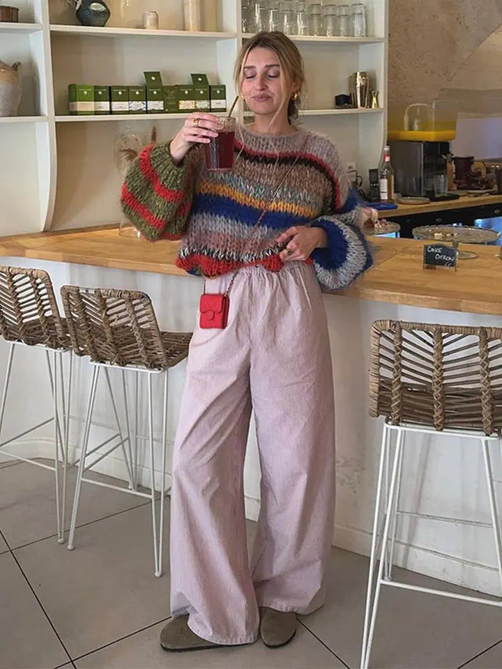 Soft women's multicolor knit sweater for winter, offering comfort and style with its long sleeves.