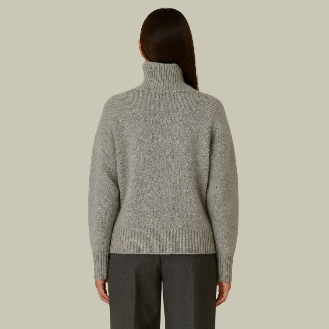 Soft gray merino wool turtleneck sweater for women, featuring a comfortable relaxed fit and knitwear design.