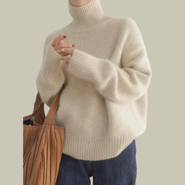 Warm beige women's relaxed fit turtleneck sweater made from premium merino wool, ideal for cold weather.