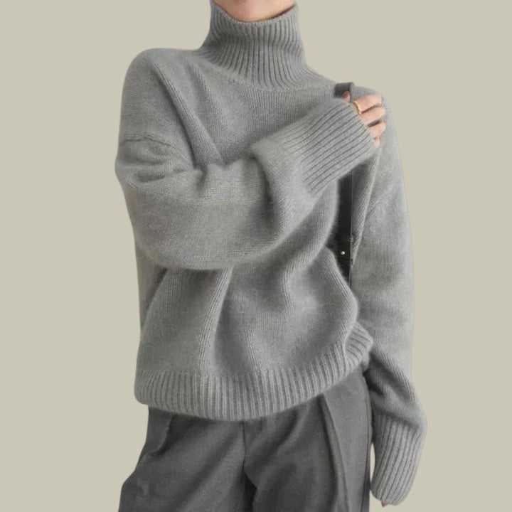 Stylish gray knitwear: women's merino wool relaxed fit turtleneck sweater, a cozy essential for fall fashion.