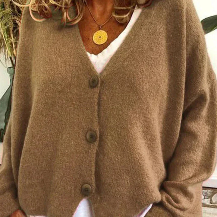 Cozy women's V-neck button cardigan in soft pink, perfect for fall layering.