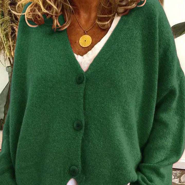 Plush women's V-neck button cardigan, rust orange, brings warmth and fashion to winter.
