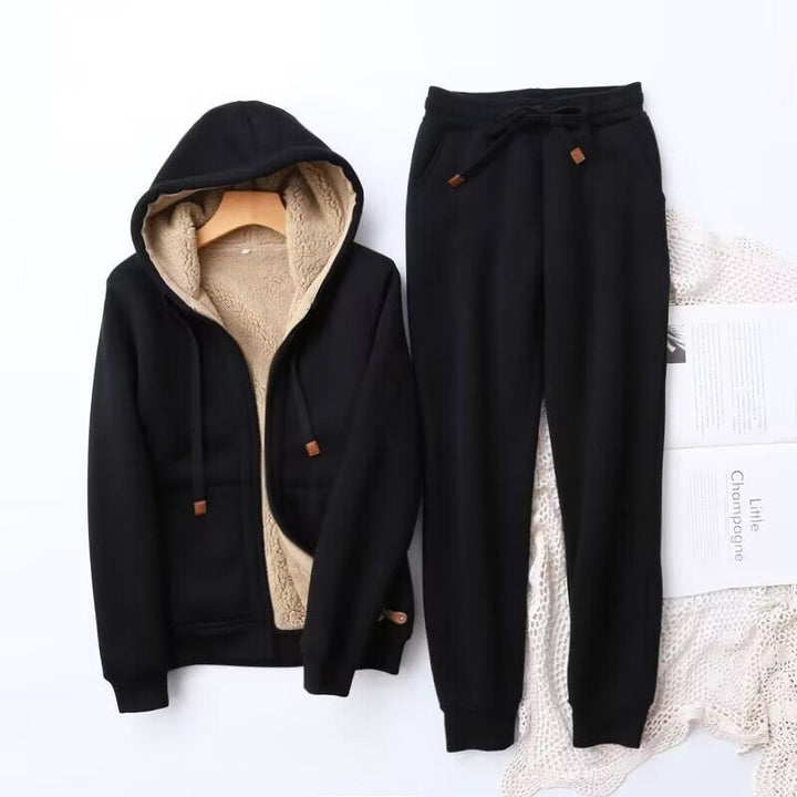 Cozy women's winter hoodie and jogger set in a soft, light grey, perfect for loungewear or athleisure.