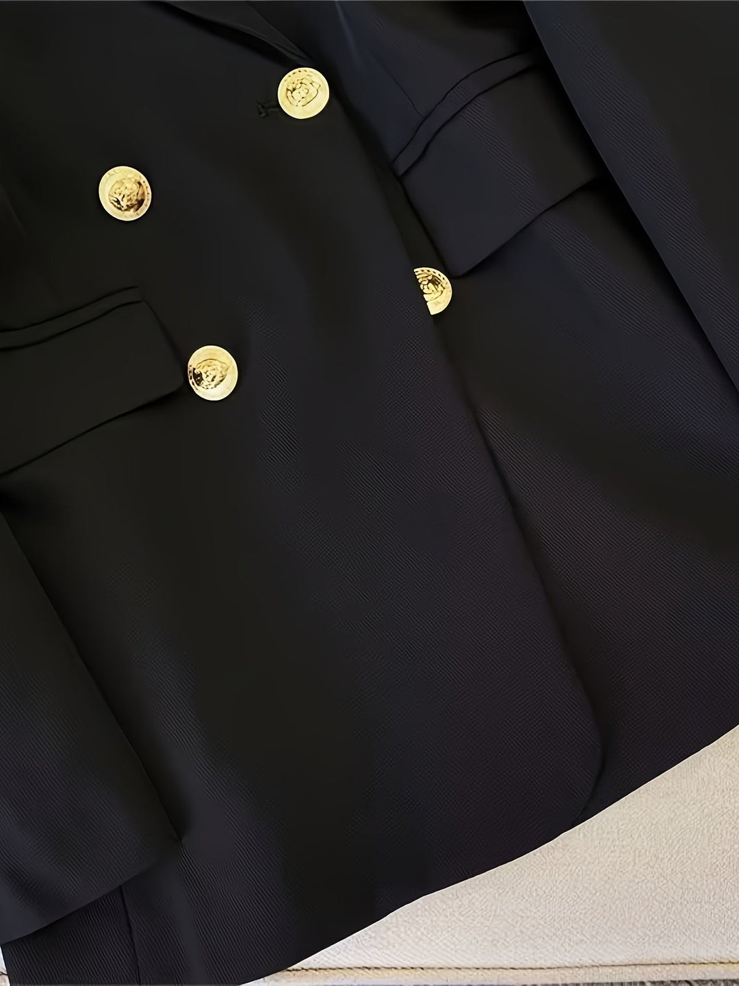 Classic cream double-breasted tailored blazer, essential professional wear for women.