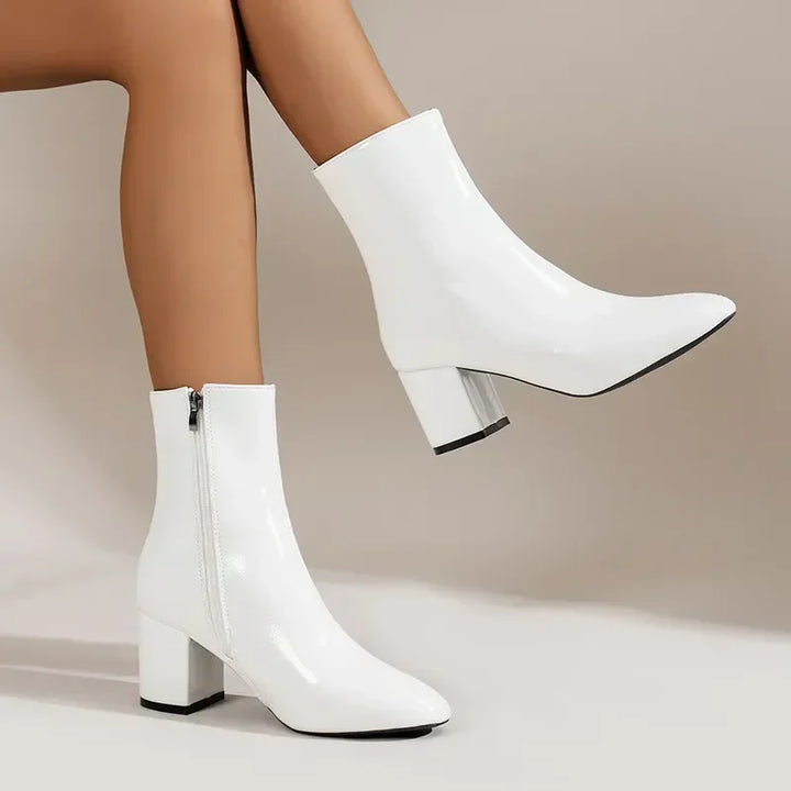 Black women's stylish heeled boots featuring a practical side zipper, ideal for versatile dress wear.