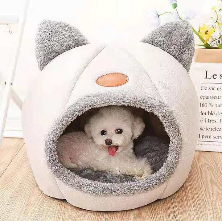 Adorable cat house pet bed with a warming feature and a plush, removable cushion for cozy naps.
