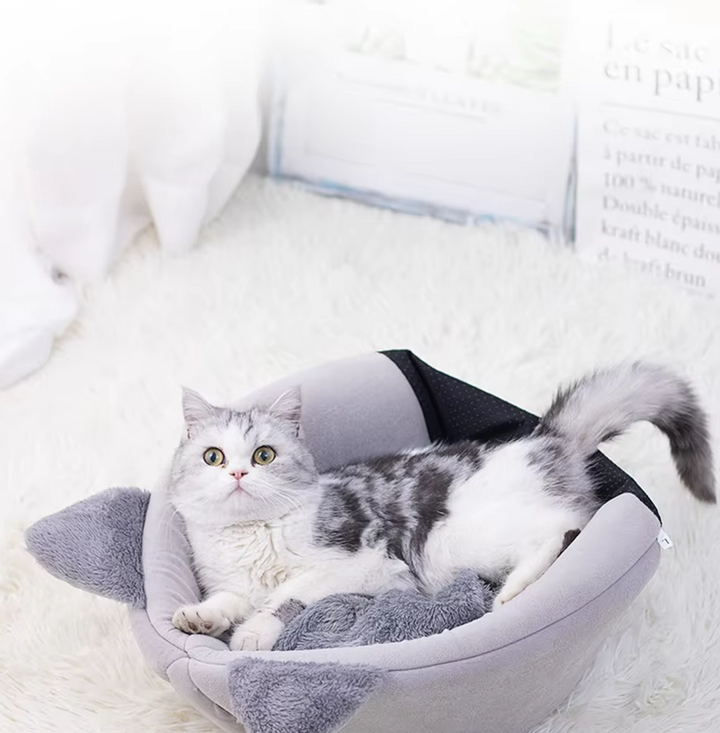 Cat-shaped warming pet bed with a convenient removable cushion for easy cleaning and extra comfort.