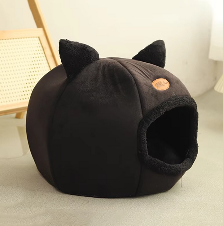 Plush, warming cat-shaped pet bed, suitable as a small dog bed. Features a removable cushion for comfort.