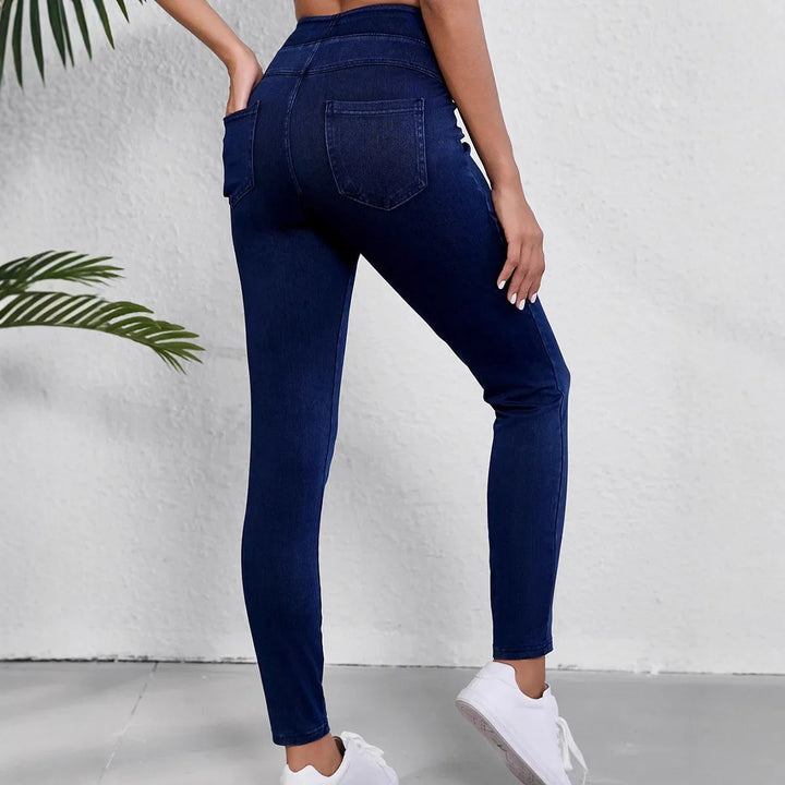 Full-body shot of a model wearing women's black slim fit high-rise stretch jeans, casual style.
