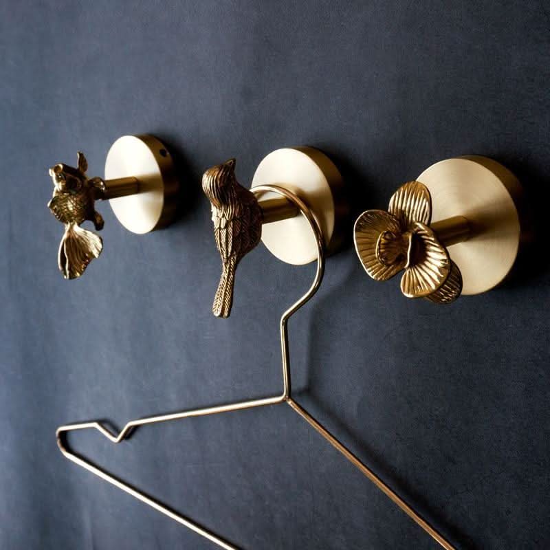 Nature-inspired brass animal coat rack with gold accents, perfect for entryway decor.