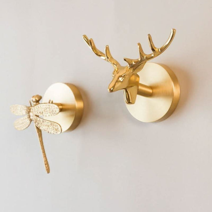 Elegant brass animal wall hooks with gold finish, ideal for jackets, hats & bags.