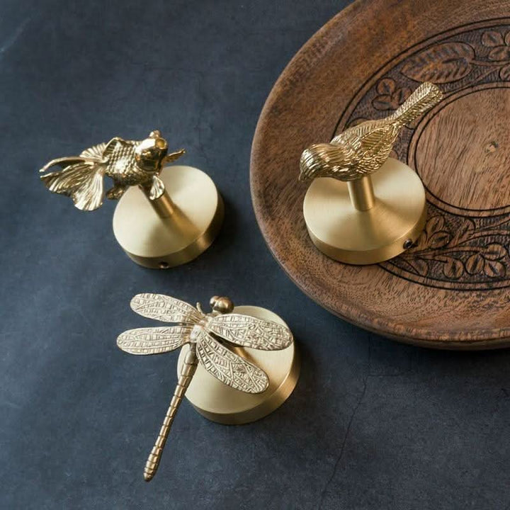 Stylish animal-themed brass wall organizer with gold details for modern home decor.