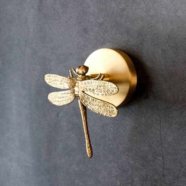 Intricate brass animal wall decor hook rack with shimmering gold accents.