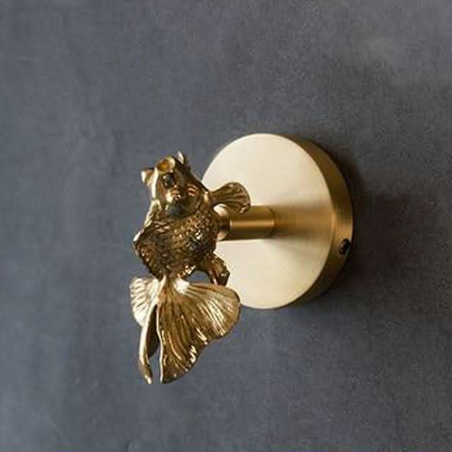 Heavy-duty brass animal wall hooks with gold highlights, durable for coats & towels.