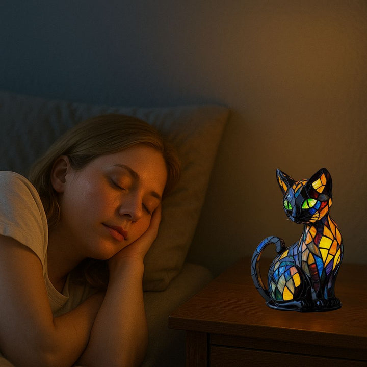 Close-up of a handcrafted mosaic cat lamp, showing intricate tile work and emitting a soft, warm glow.