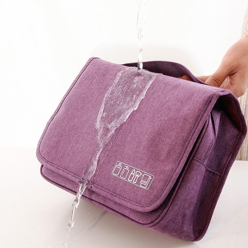 Organized travel essentials inside the open deluxe hanging toiletry bag.
