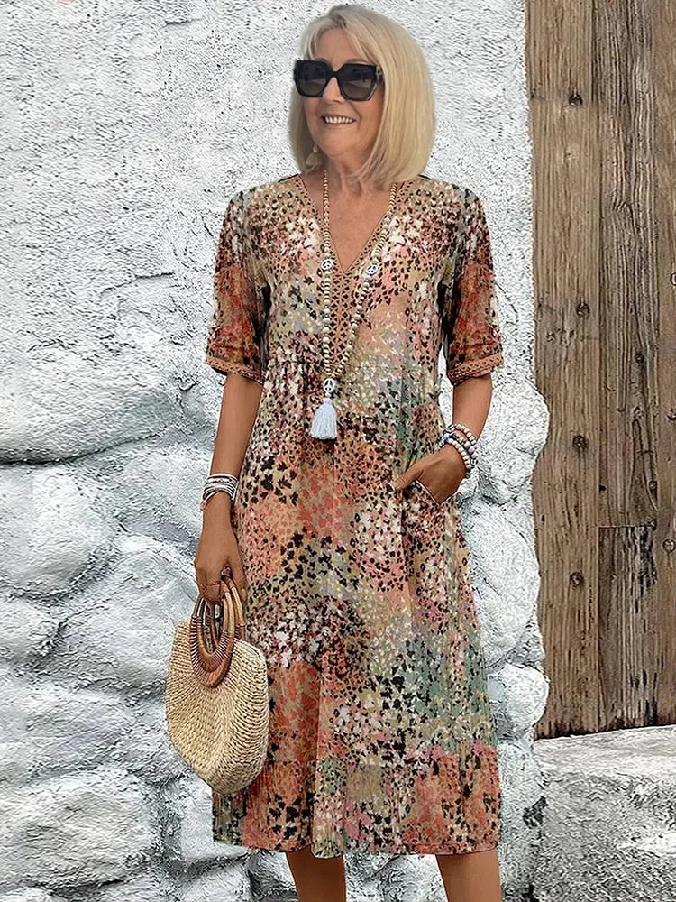 Women's vibrant A-line midi dress with flattering tummy coverage. Elegant and flowy for summer occasion wear.