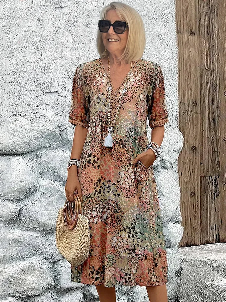 Women's vibrant A-line midi dress with flattering tummy coverage. Elegant and flowy for summer occasion wear.