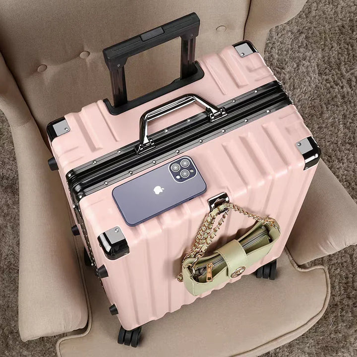 Elegant silver hard shell travel case, aluminum frame, & spinner wheels, perfect for modern travelers.