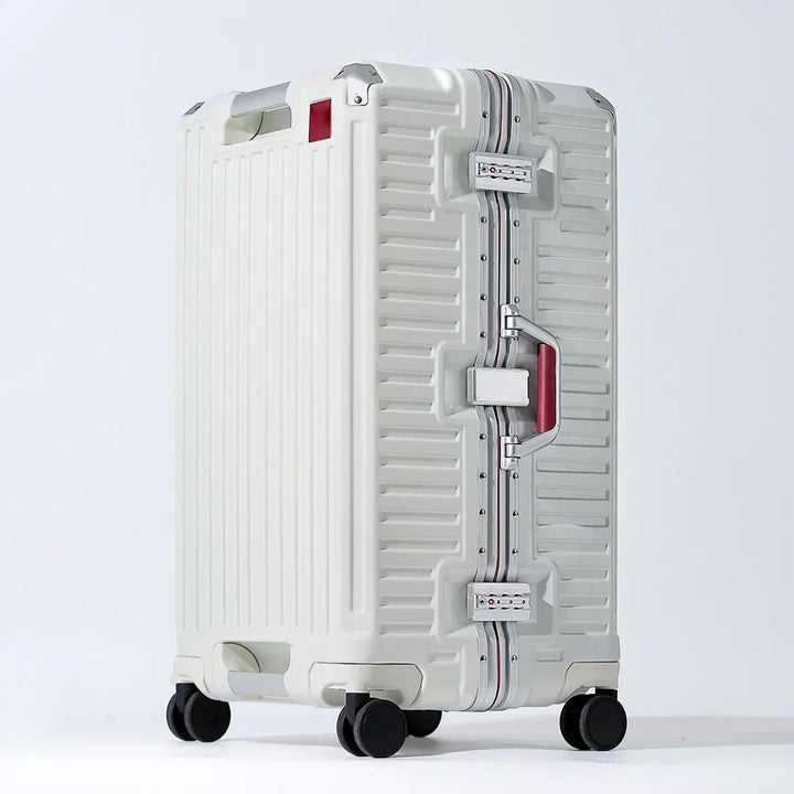 Ergonomic wide grip handle on a hard shell travel suitcase, with smooth spinner wheels for comfortable luggage transport.