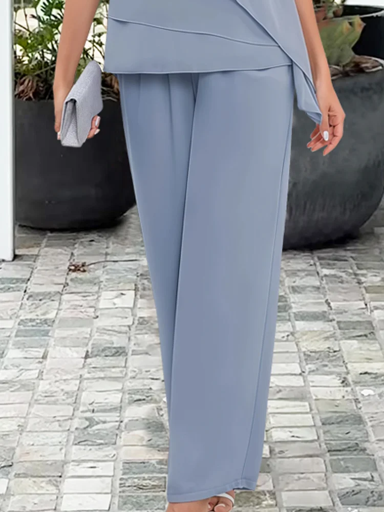 Comfortable women's two-piece lounge set in a neutral color, featuring an asymmetric top and wide-leg pants.