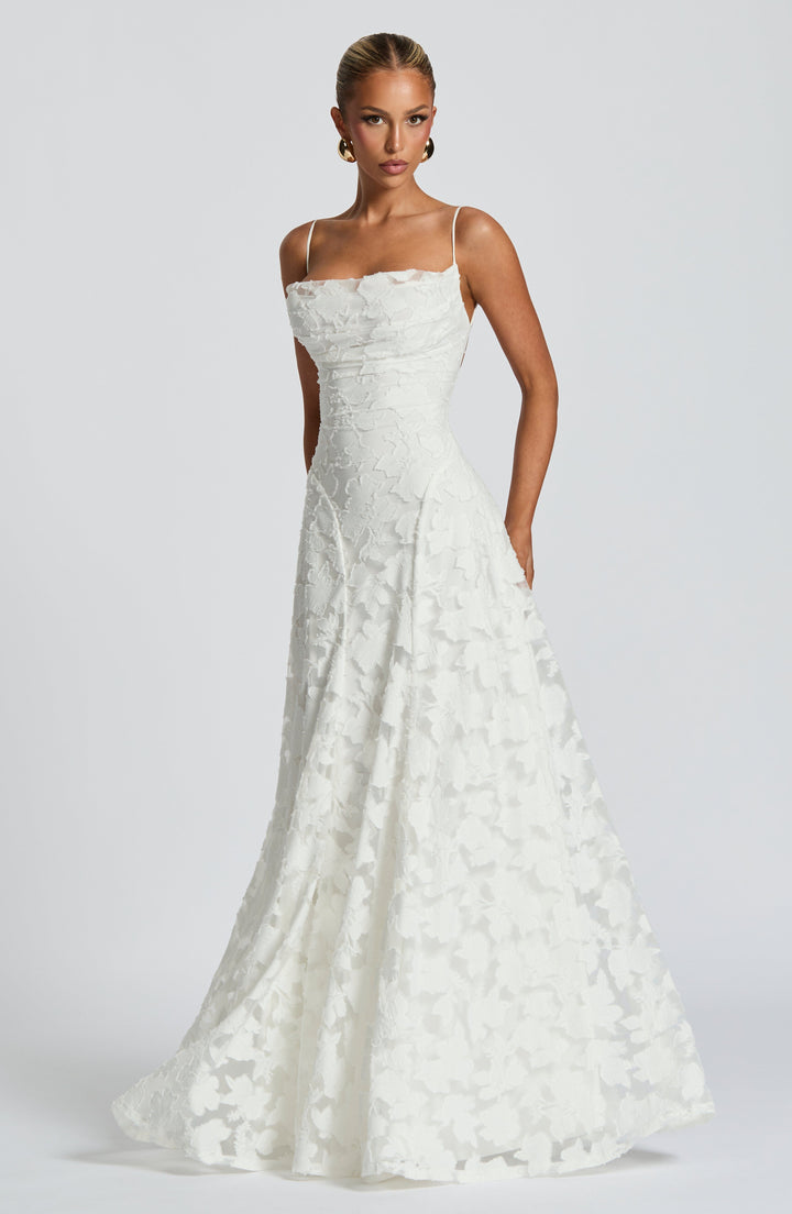 Backless spaghetti strap formal gown for women, elegant, flowy, high-waisted maxi dress.