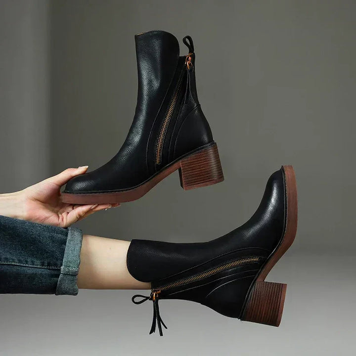 Elegant black ankle boots for women, streamlined design, perfect for fall and winter fashion.