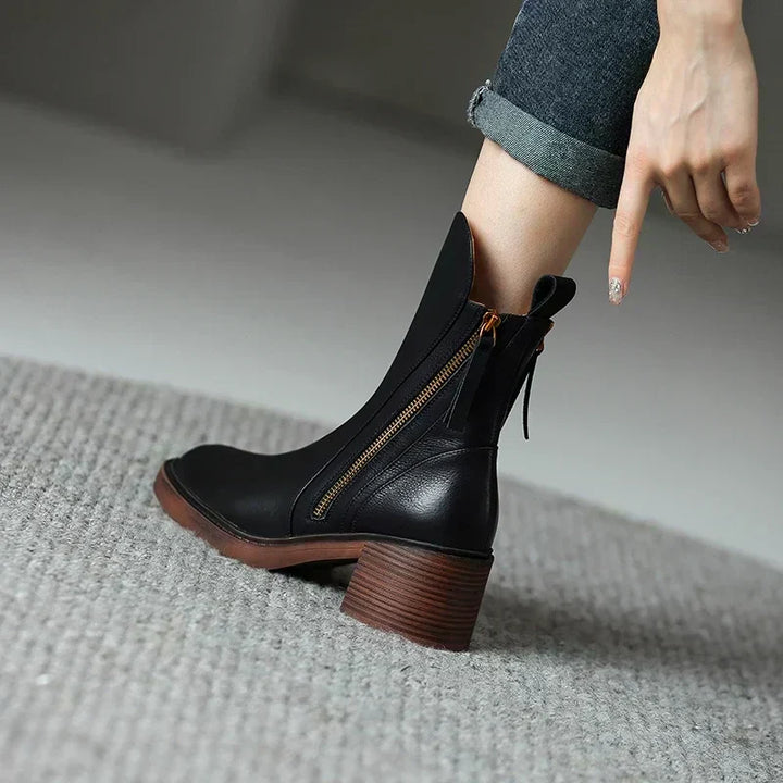 Women's comfortable black ankle boots with elegant streamlined silhouette, versatile footwear choice.