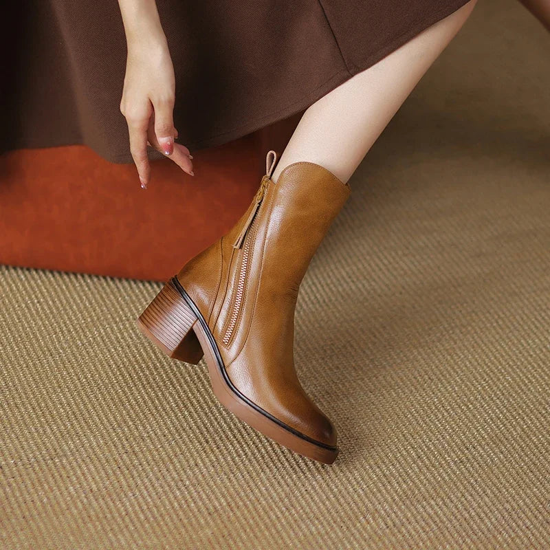 Streamlined black ankle boots for women, promoting elegant style and comfortable wear, fall fashion.