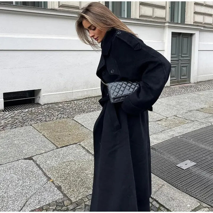 Women's black trench coat, double-breasted with wide lapels, a timeless outerwear piece for fashion.