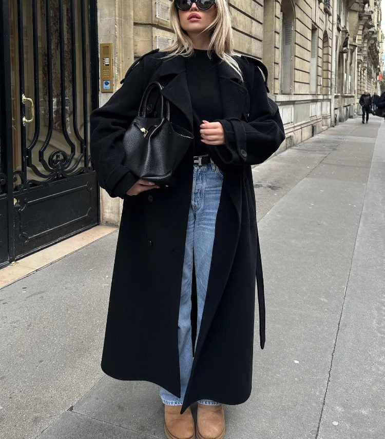 Sophisticated women's black double-breasted trench coat, offering warmth and style for seasonal wear.