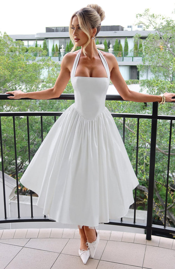 Elegant black halter neck midi dress for wedding guests, front view, in studio.