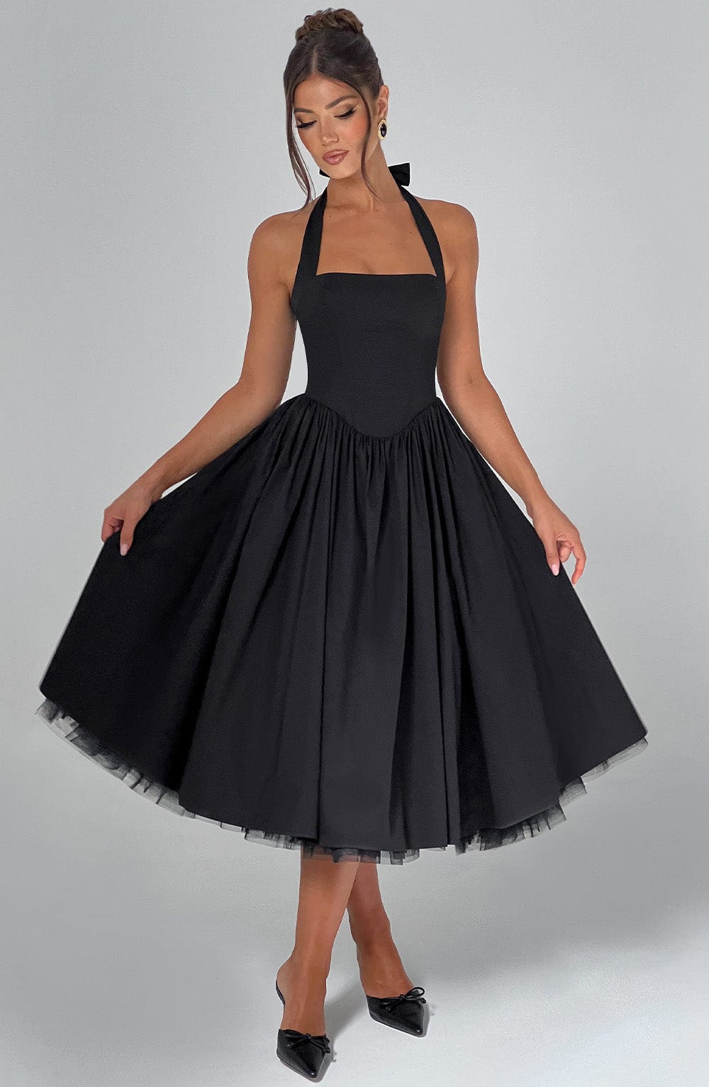 Elegant black party dress with a flattering halter neck design and midi cut.
