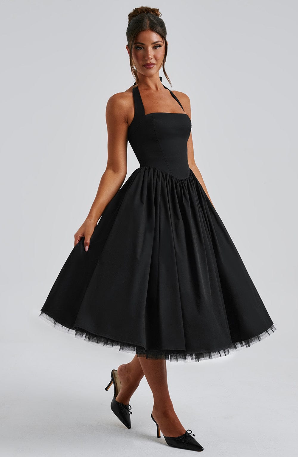 Women's classic black halter neck midi dress, a timeless choice for any event.
